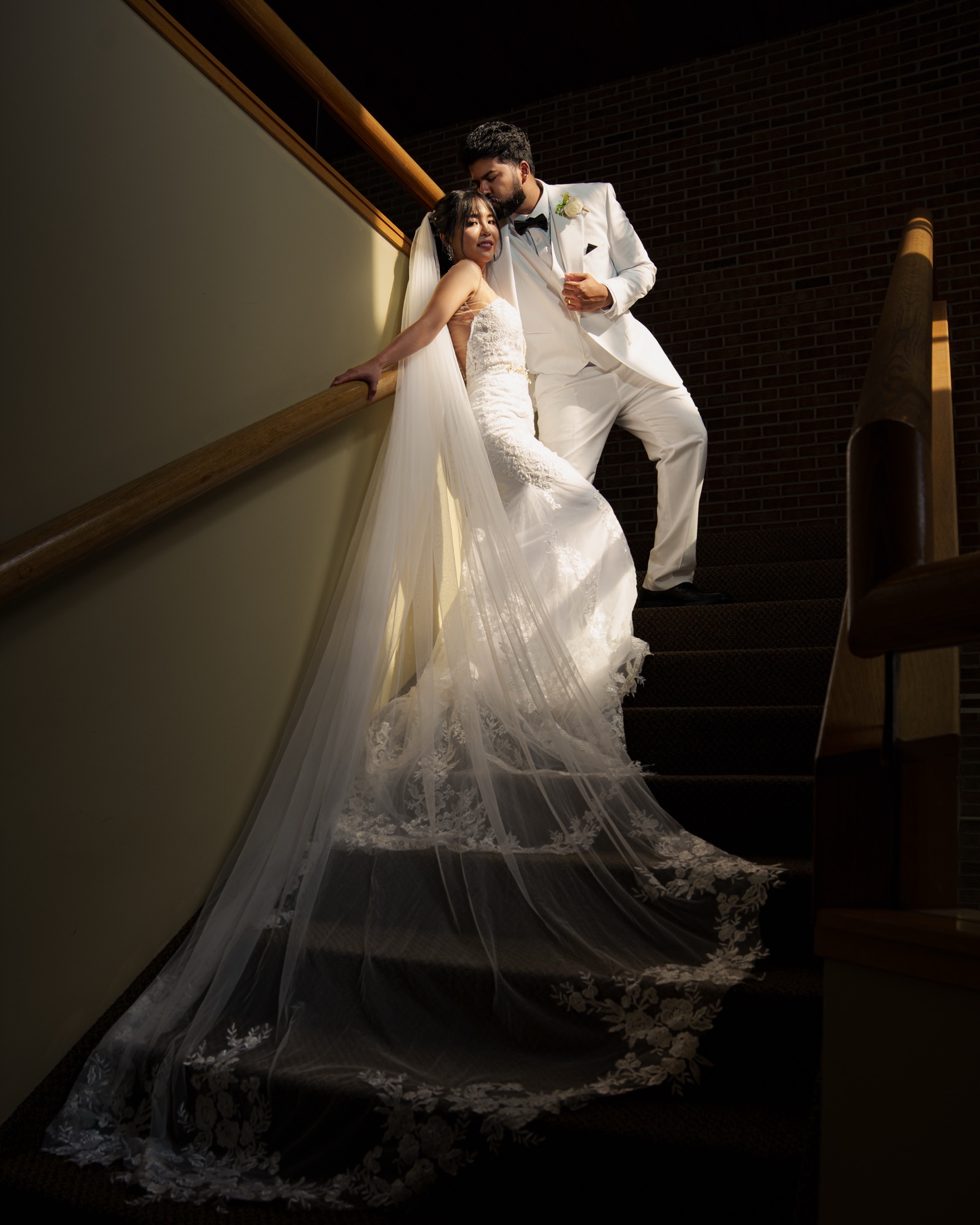 Bride on a staircase, veil trailing